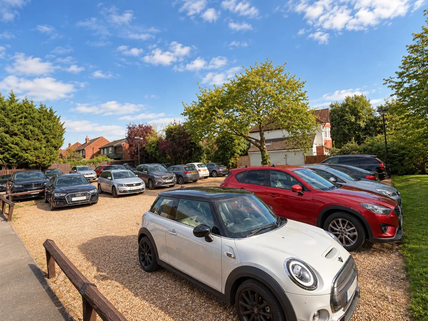 Cars parked in the gravel car park beside The Prince of Wales